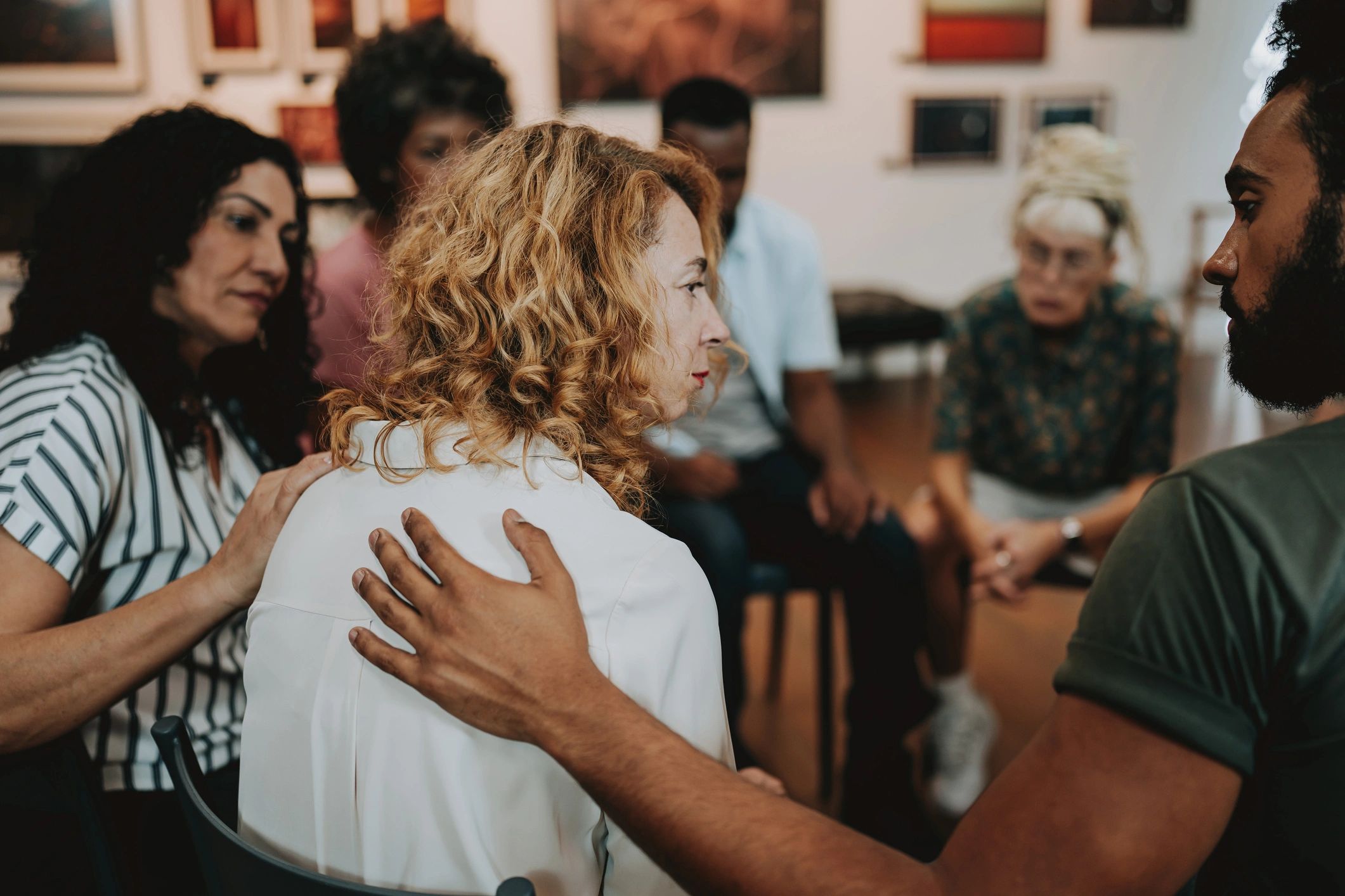 Diverse people supporting each other in a community mental health setting